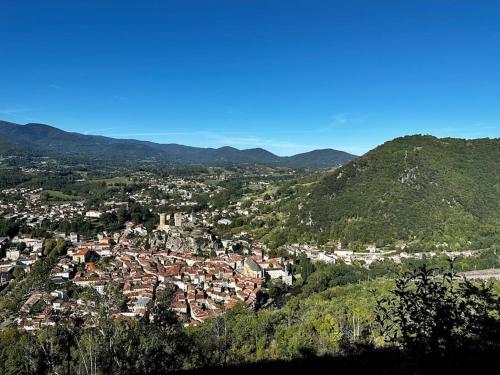 an aerial view of a town in the mountains at 3 pièces spacieux plein centre, parking,clim, terrasse, jardin in Foix