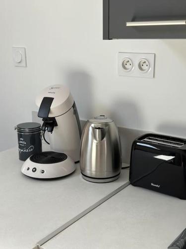 a kitchen counter with a coffee maker and a toaster at 3 pièces spacieux plein centre, parking,clim, terrasse, jardin in Foix