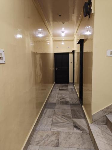 a hallway of a building with a tile floor at Hotel Ruby and Restaurant in Srinagar