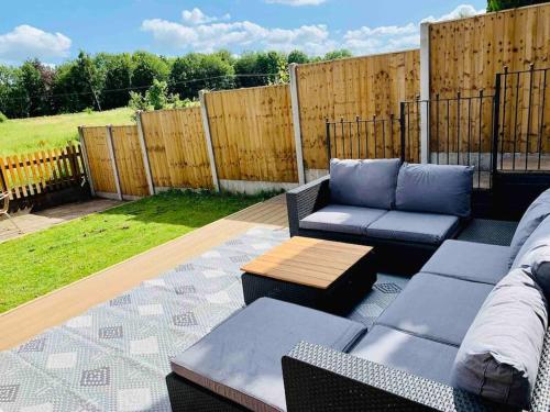 a patio with a couch and a coffee table at Chapter One - Ashbourne in Mapleton