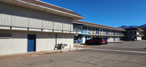 a parking lot next to a building with a parking meter at Motel 6-Alamogordo, NM in Alamogordo