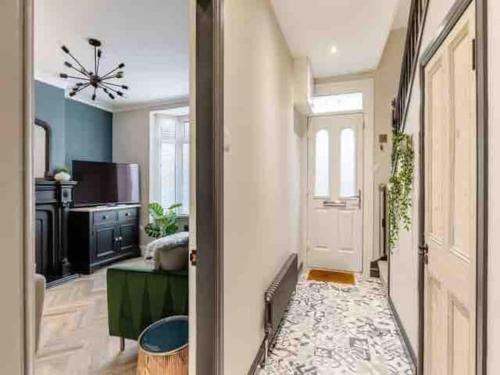 a hallway with a white door and a living room at Chapter One - Ashbourne in Mapleton