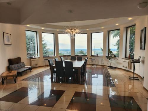 a dining room and living room with a table and chairs at Raca Retreat in Rača