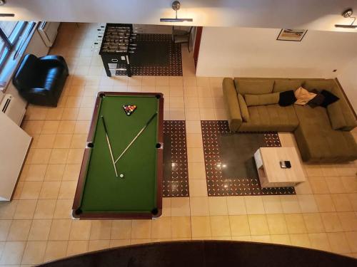 an overhead view of a living room with a pool table at Raca Retreat in Rača