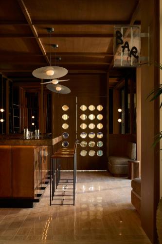 a lobby with a bar with a table and chairs at Ace Hotel & Swim Club Athens in Athens