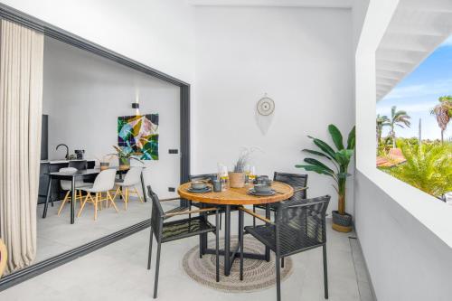 a dining room with a table and chairs on a balcony at The Sunset - Luxurious Penthouse near Jan Thiel Beach in Jan Thiel