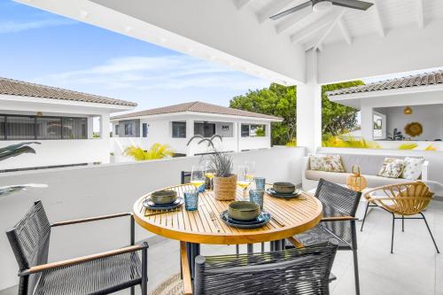 a patio with a wooden table and chairs at The Sunset - Luxurious Penthouse near Jan Thiel Beach in Jan Thiel