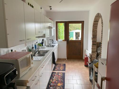 a kitchen with a sink and a microwave at Perk25A in Steenokkerzeel