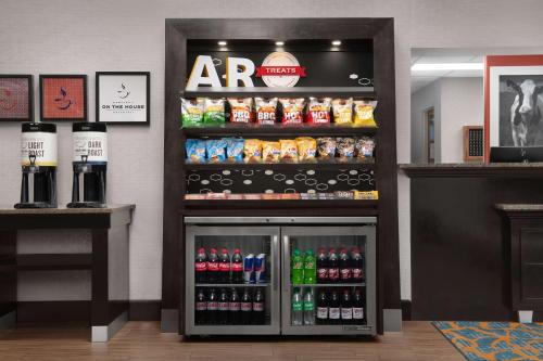 a drink cooler in a store with drinks at Hampton Inn Russellville in Russellville