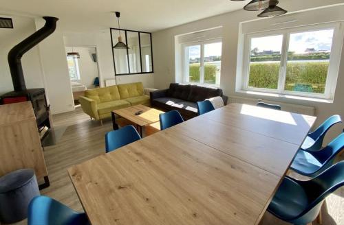 a living room with a large wooden table and chairs at Saint-Pol family house garden fully equipped 12 people in Saint-Pol-de-Léon