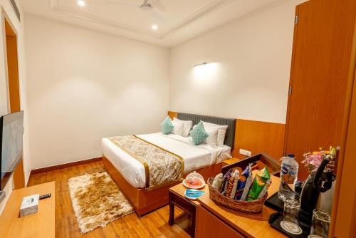 a hotel room with a bed and a desk with a television at Xenious Micro in Amritsar