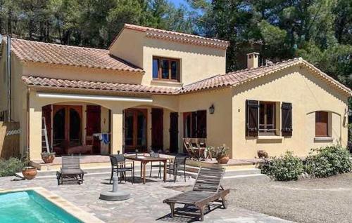 a house with a pool and a table and chairs at Lovely Home In Roquebrun With Kitchen in Roquebrun