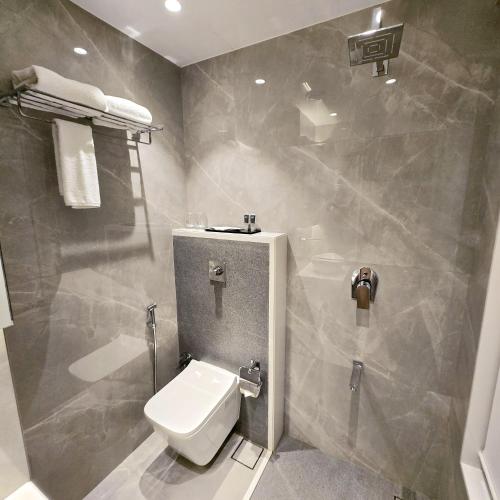 a bathroom with a white toilet in a room at InstaFeel Hotel in Navi Mumbai