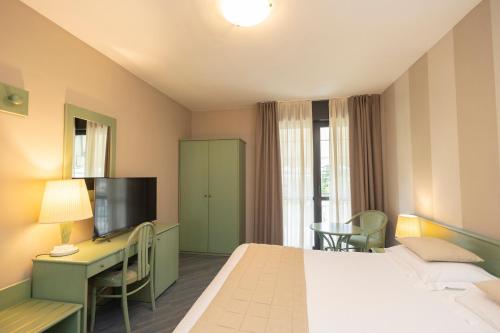 Postel nebo postele na pokoji v ubytování Hotel Berta