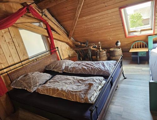two beds in a room with wooden walls at Rustikales Landhaus in Colmberg