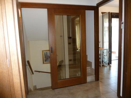 a glass door in a room with a hallway at Villa Green Harmony in Bussolengo