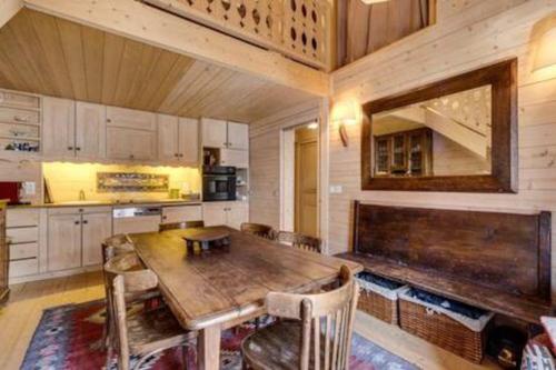 a kitchen with a large wooden table and chairs at Chalet Ancolie 2e Appartement cosy dans un chalet in Val dʼIsère