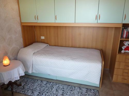 a small bedroom with a bed and a table at Villa Green Harmony in Bussolengo