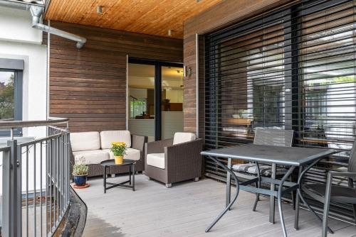 a patio with a table and chairs on a deck at Ferienwohnung Refugium Nest in Sigmaringen