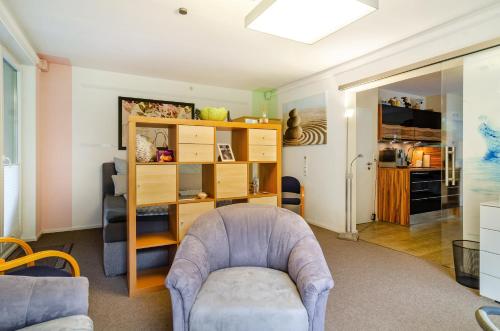 a living room with a couch and a chair at Ferienwohnung Refugium Nest in Sigmaringen