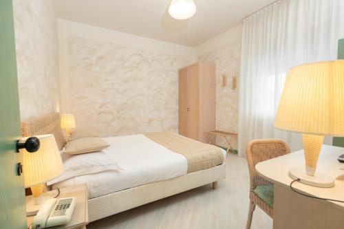 Postel nebo postele na pokoji v ubytování Hotel Berta