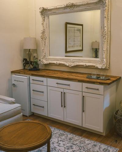 a mirror on top of a dresser in a living room at Warner Hotel in Bisbee