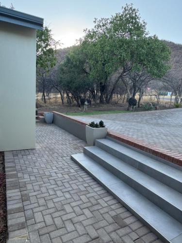 a set of stairs next to a building at De Marea villa in Naboomspruit