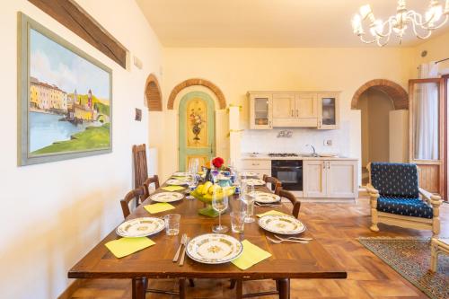 a dining room with a wooden table with food on it at Borgo Badia by VacaVilla in Badia