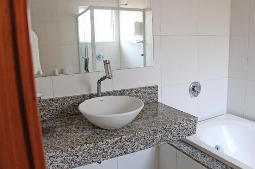 a bathroom with a bowl sink on a counter at Soder Hotel in Santa Cruz do Sul