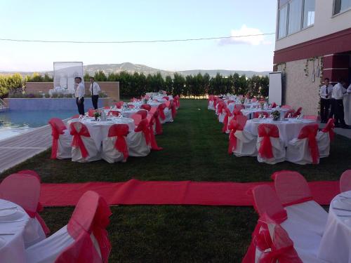 a row of tables with red and white table cloths at Hotel Labella Bergama in Bergama