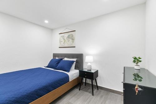 a bedroom with a blue bed and a night stand at Bahia Mar Solare Beachfront Resort Condos with Two Pools in South Padre Island