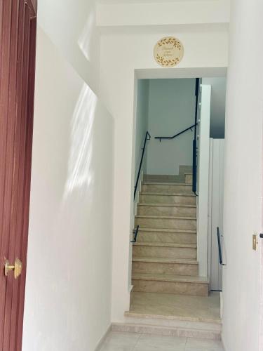 a hallway with a stairway with a stair case at Casa Katarina in Calatafimi