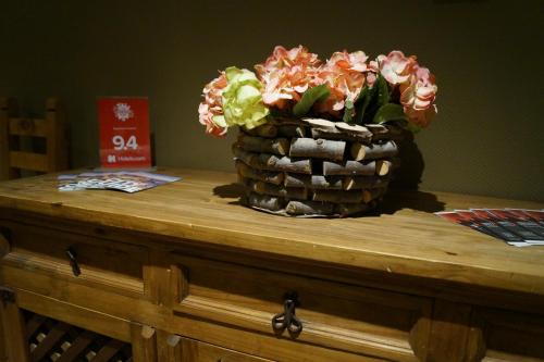 a basket of flowers sitting on top of a table at Apartment Central Leipzig - City in Leipzig
