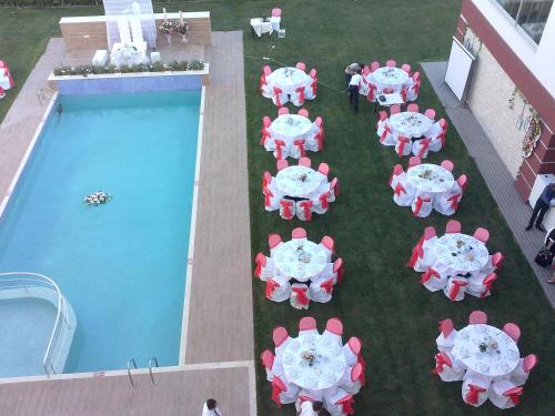an overhead view of tables and chairs next to a pool at Hotel Labella Bergama in Bergama