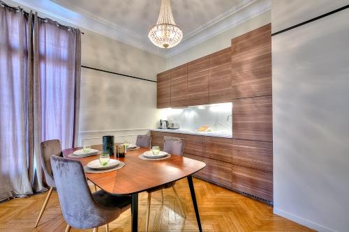 une salle à manger avec une table et des chaises en bois dans l'établissement FAR5 - 3 chambres à deux pas de la rue d'Antibes, à Cannes