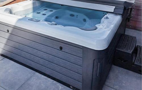 a jacuzzi tub sitting in the middle of a bathroom at Stunning Home In Bergen Aan Zee in Bergen aan Zee