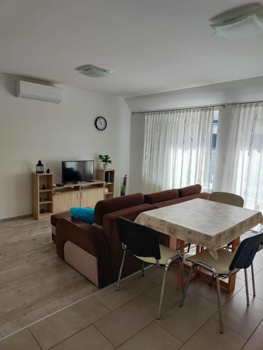 a living room with a couch and a table at Hegin Szigeti Apartman in Pécs