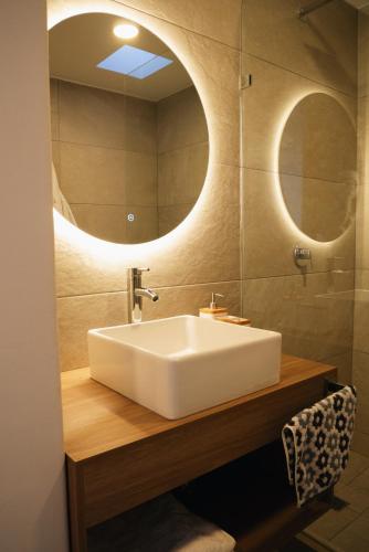 a bathroom with a white sink and a mirror at Casa Lomas in Oaxaca City