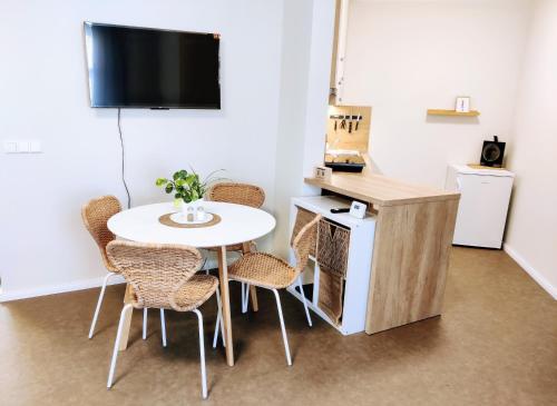 a room with a table and chairs and a tv at Králova Výšina in Ústí nad Labem