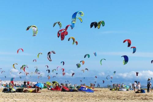 a group of people flying kites on a beach at Costa by Hawkins Algeciras - Interior 1B in Algeciras