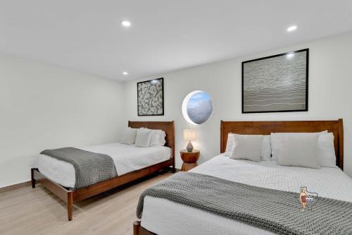 a bedroom with two beds and a chair in it at Bahia Mar Solare Beachfront Resort Condos with Two Pools in South Padre Island