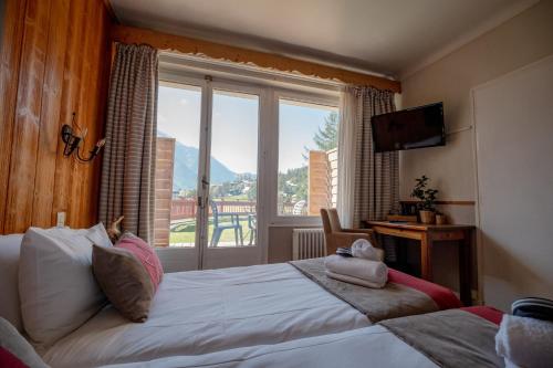 Katil atau katil-katil dalam bilik di Chalet Hôtel La Sapinière