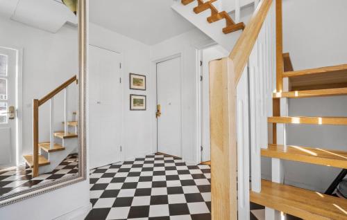 a hallway with a mirror and a checkered floor at Sommerhus in Skanderborg
