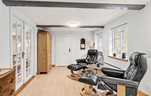 a therapy room with two chairs and a table at Three-Bedroom Holiday Home In Tranekar in Østerhuse