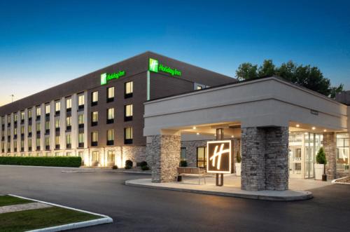 a hotel building with a sign in front of it at Holiday Inn Cleveland-Mayfield by IHG in Mayfield