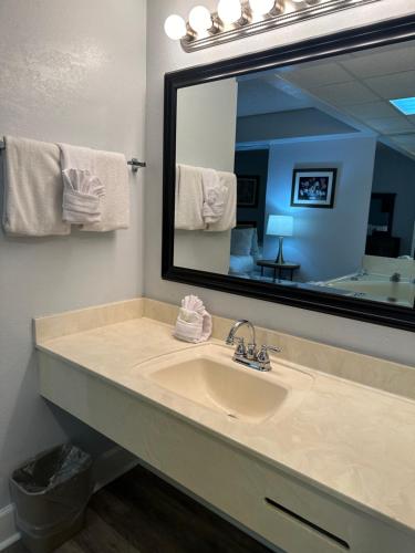a bathroom with a sink and a large mirror at River Place Condos #409 1BD, 2Bath in Pigeon Forge