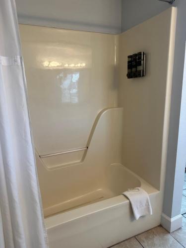 a bathroom with a bath tub with a shower curtain at River Place Condos #409 1BD, 2Bath in Pigeon Forge