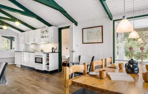 a kitchen and dining room with a table and chairs at Lovely Home In Fjerritslev With Wifi in Fjerritslev