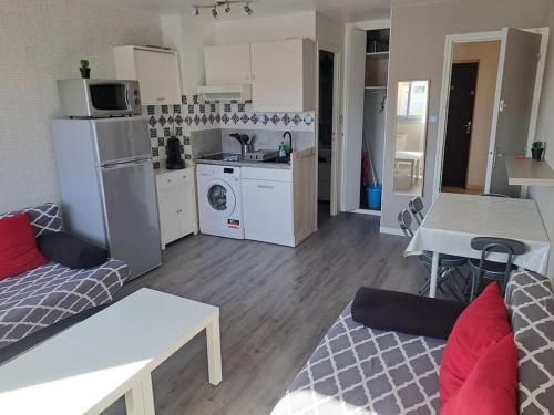 un soggiorno con divano e cucina di Asphodèle, Joli studio avec parking, 2 pas des plages et du Port a Cap d'Agde