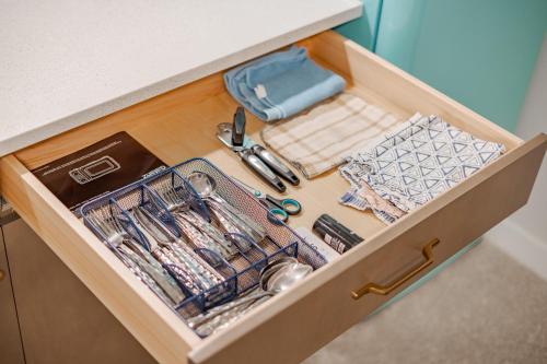 a drawer in a kitchen with utensils at Luxe Suite close to Spruce Meadows in Priddis
